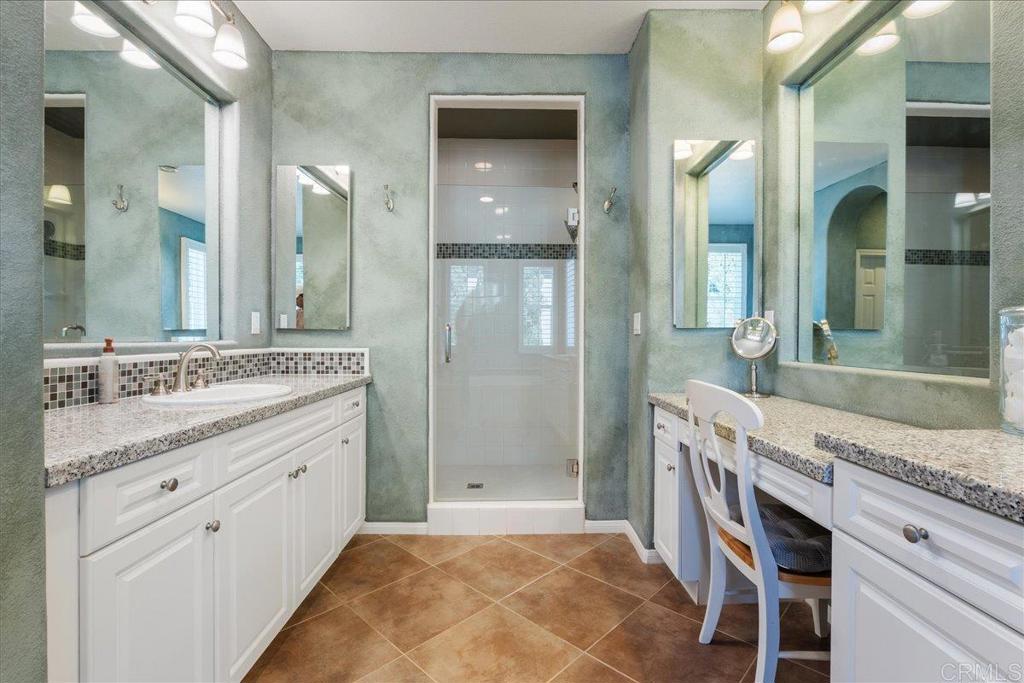 2667 Fallsview Road San Marcos, CA 92078 - Photo 43 of 54 a bathroom with a granite countertop sink a mirror and a shower