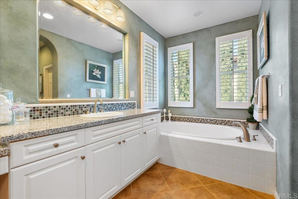 2667 Fallsview Road San Marcos, CA 92078 - Photo 45 of 54 a bathroom with a tub sink and mirror