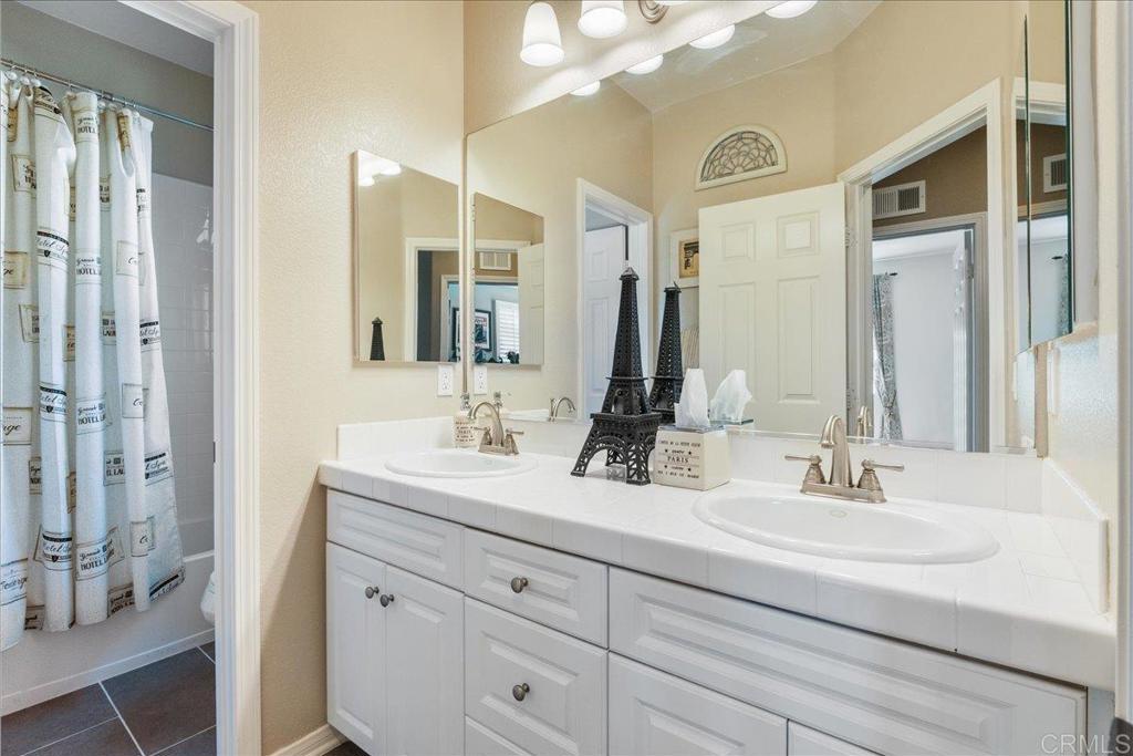 2667 Fallsview Road San Marcos, CA 92078 - Photo 46 of 54 a bathroom with a double vanity sink mirror and next to a window