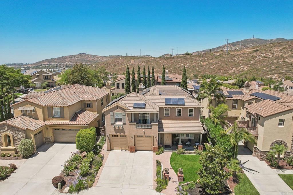 2667 Fallsview Road San Marcos, CA 92078 - Photo 5 of 54 an aerial view of a residential apartment building with a yard and mountain in the background
