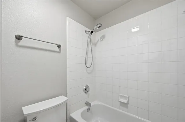 a bathroom with a toilet and shower