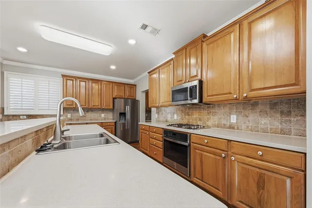 a kitchen with stainless steel appliances granite countertop a sink and cabinets