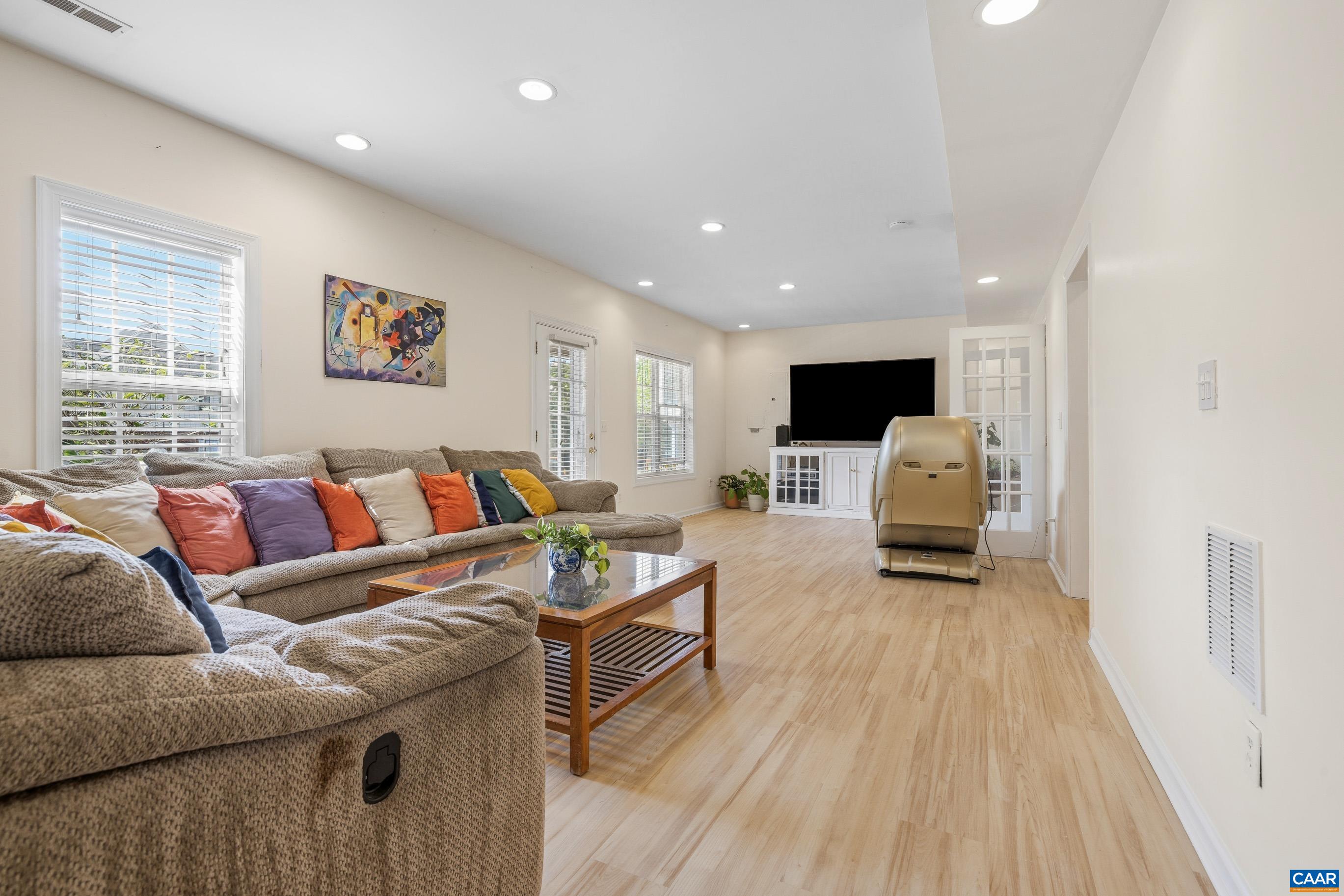 1236 Amber Ridge Road Charlottesville, VA 22901 - Photo 40 of 56 a living room with furniture and a wooden floor