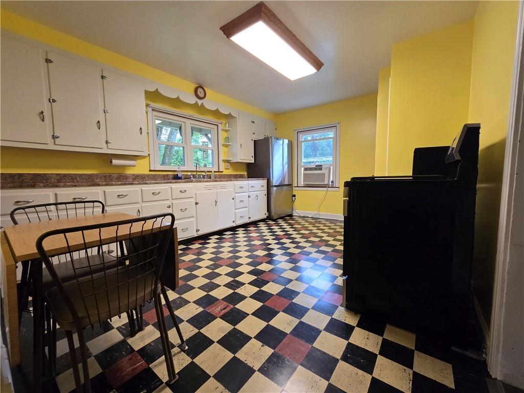 368 Pittsburgh Road Butler, PA 16002 - Photo 5 of 28 a kitchen with a checkered floor and a stove top oven