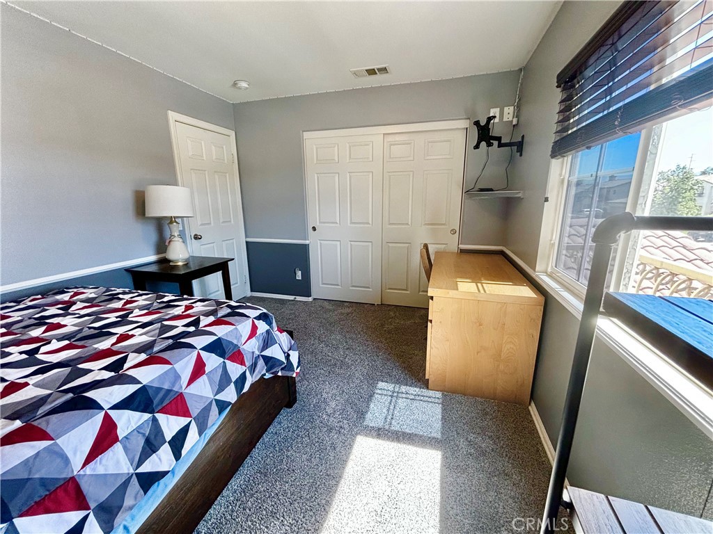 1005 Garrett Way San Jacinto, CA 92583 - Photo 19 of 29 a bedroom with a bed and wooden floor