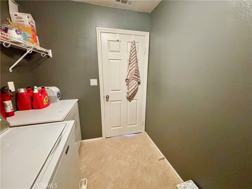 1005 Garrett Way San Jacinto, CA 92583 - Photo 22 of 29 a utility room with a hallway view with washer and dryer