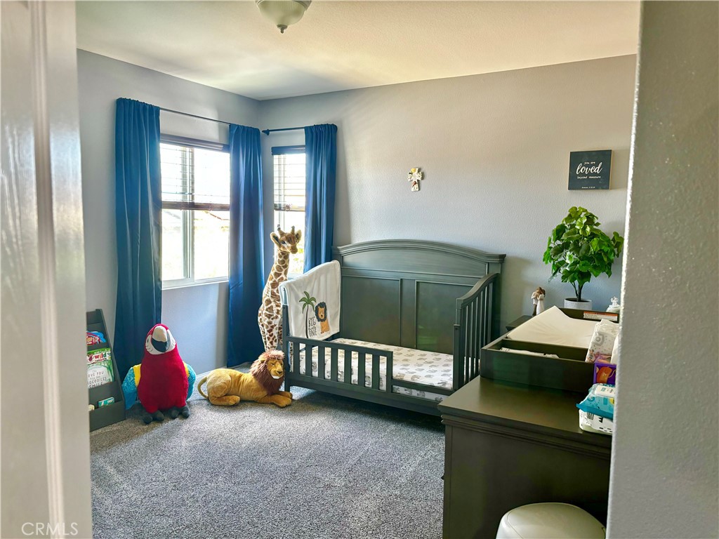 1005 Garrett Way San Jacinto, CA 92583 - Photo 23 of 29 a bedroom with furniture and a potted plant