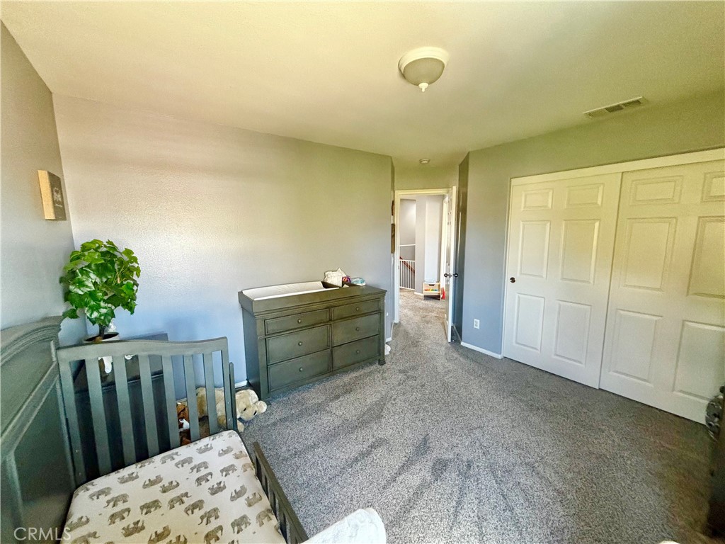 1005 Garrett Way San Jacinto, CA 92583 - Photo 24 of 29 a bed room with a bed and a window