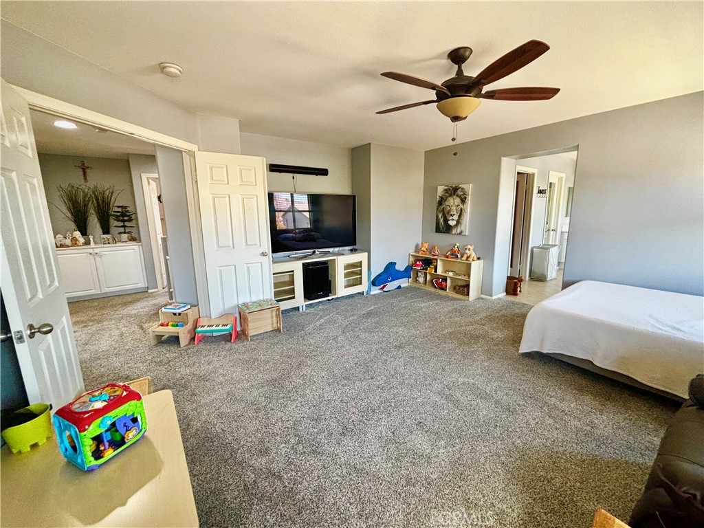 1005 Garrett Way San Jacinto, CA 92583 - Photo 25 of 29 a bedroom with furniture and a flat screen tv