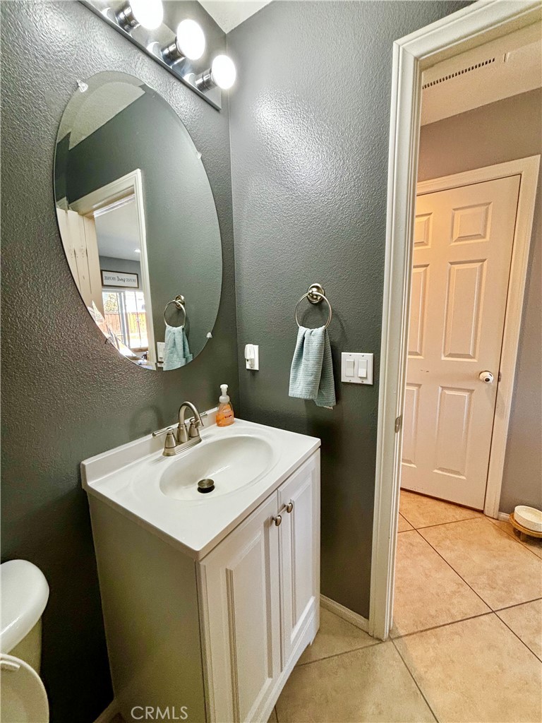 1005 Garrett Way San Jacinto, CA 92583 - Photo 7 of 29 a bathroom with a sink and a mirror