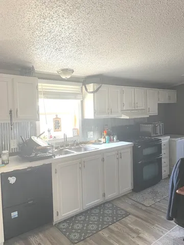 a kitchen with sink and cabinets