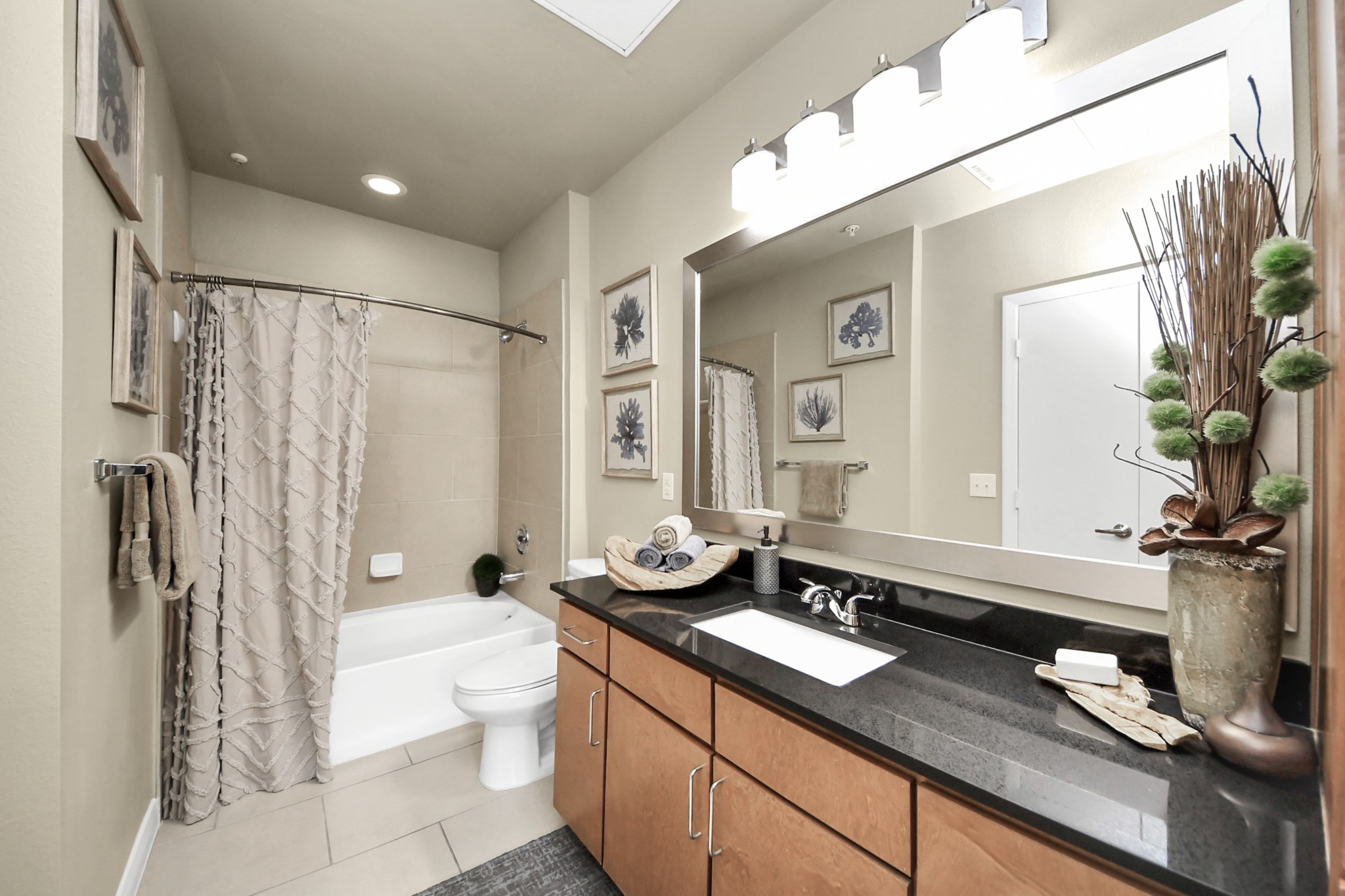 5455 Richmond Avenue, Unit 3046 Houston, TX 77056 - Photo 46 of 50 a bathroom with a granite countertop sink a toilet a mirror and shower