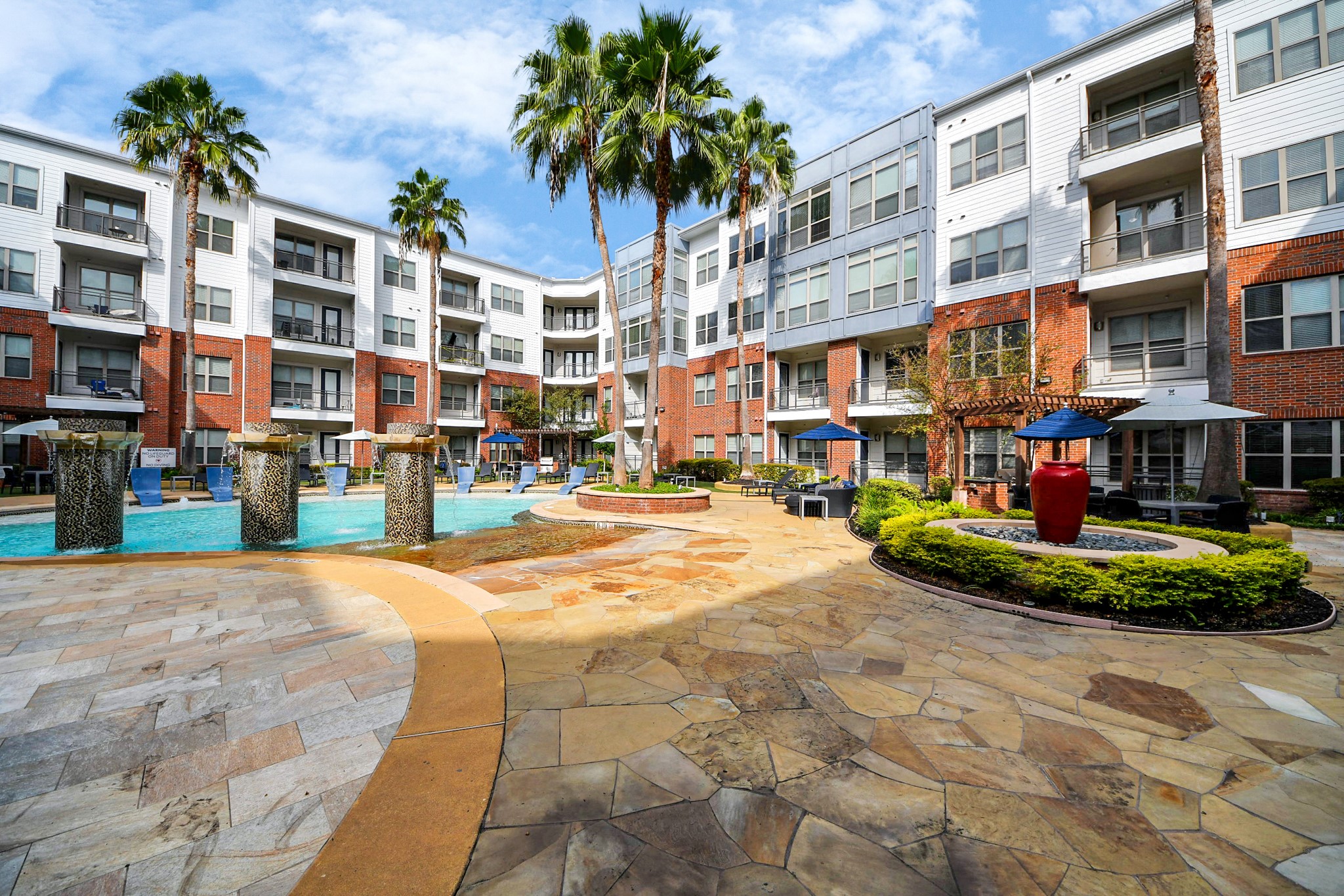 5455 Richmond Avenue, Unit 3046 Houston, TX 77056 - Photo 16 of 50 a front view of a building with a garden and plants