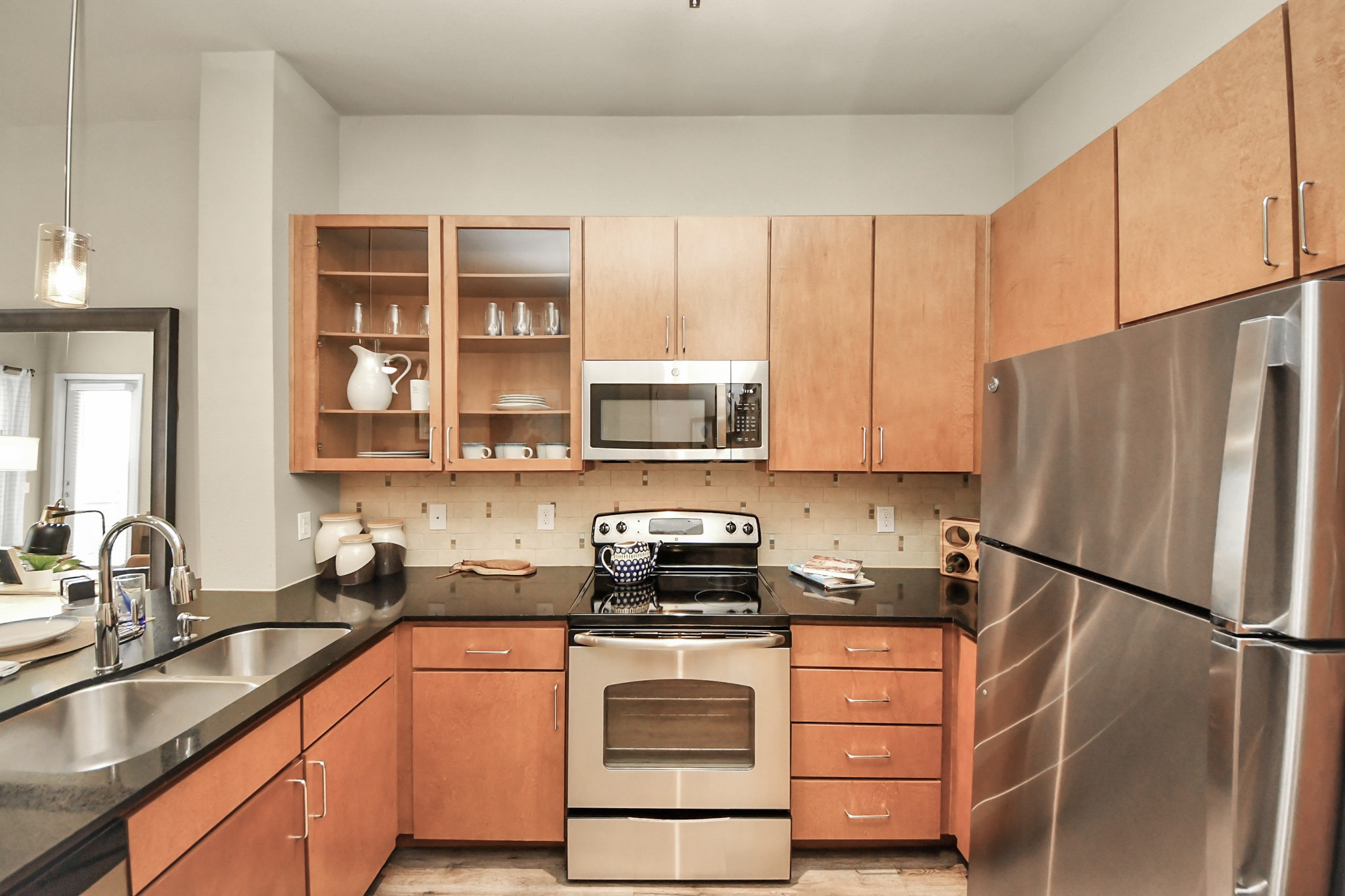 5455 Richmond Avenue, Unit 3046 Houston, TX 77056 - Photo 33 of 50 a kitchen with stainless steel appliances a refrigerator sink and cabinets