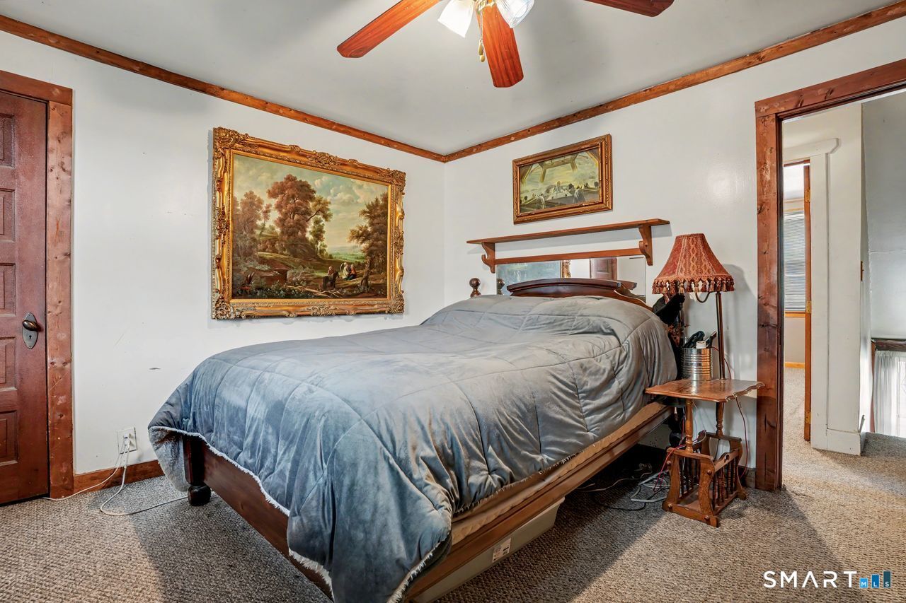 74 Maple Street Seymour, CT 06483 - Photo 25 of 40 a bedroom with a bed and painting on the wall