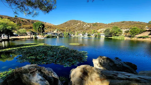 a view of a wooden floor and lake in back