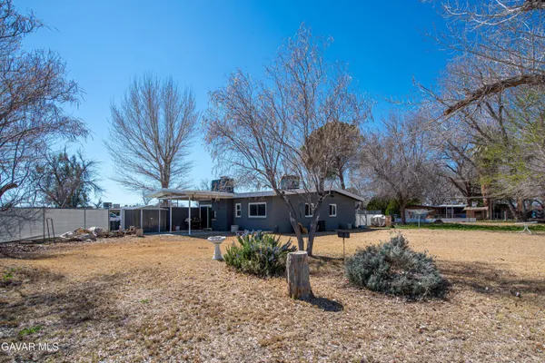 a view of a yard with a house in the background