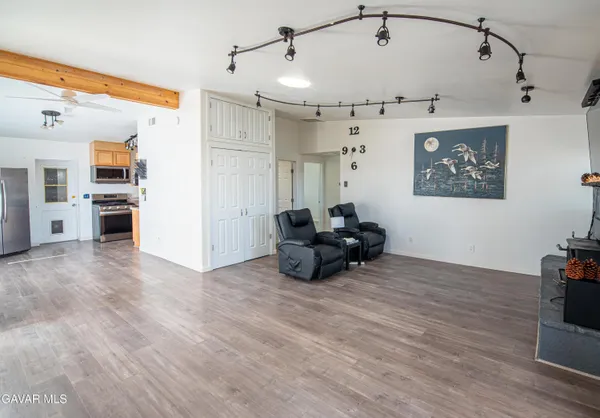 a view of a livingroom with furniture and a flat screen tv