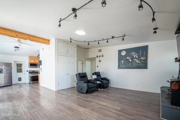a living room with furniture and kitchen view