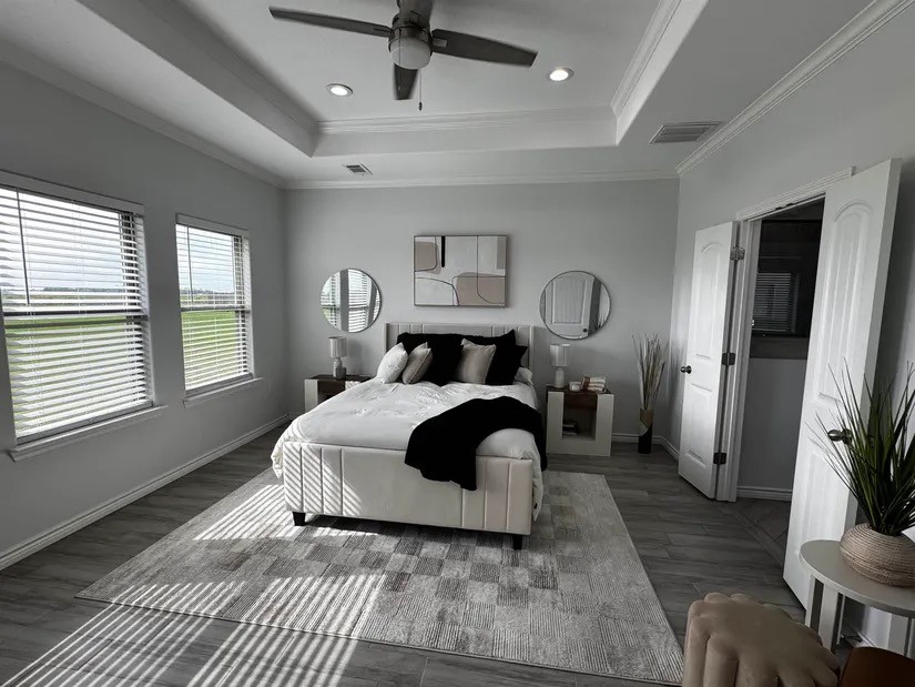 2295 Diamond D Lane Beaumont, TX 77713 - Photo 10 of 40 a bedroom with a bed a mirror on dresser and a window