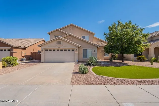 a view of a house with swimming pool and a yard