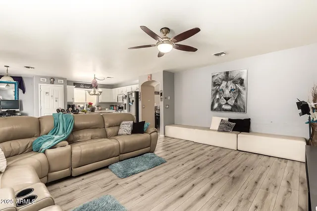 a living room with furniture and wooden floor