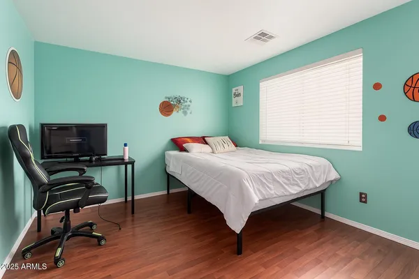 a bedroom with a workspace