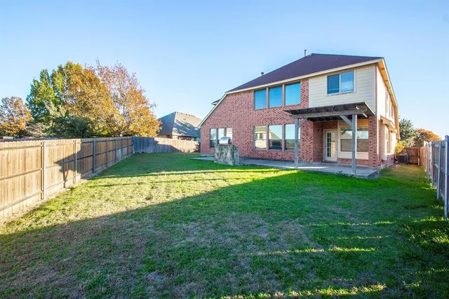 a front view of a house with a yard and outdoor seating