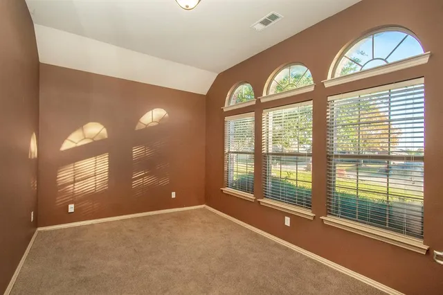 a view of an empty room with a fireplace and a large window