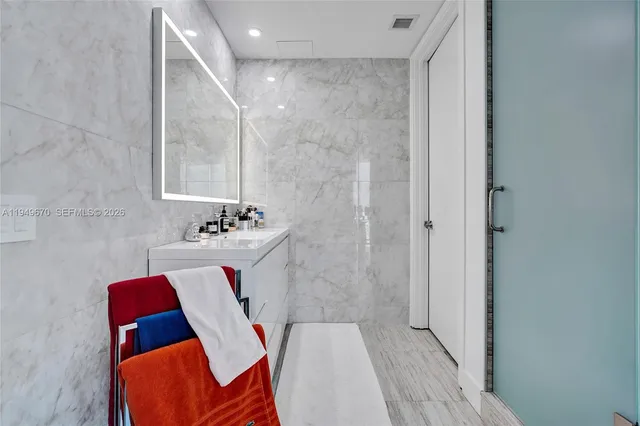 a bathroom with a bathtub and shower