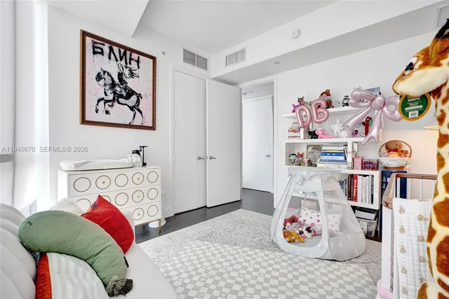 a bedroom with a bed and a book shelf
