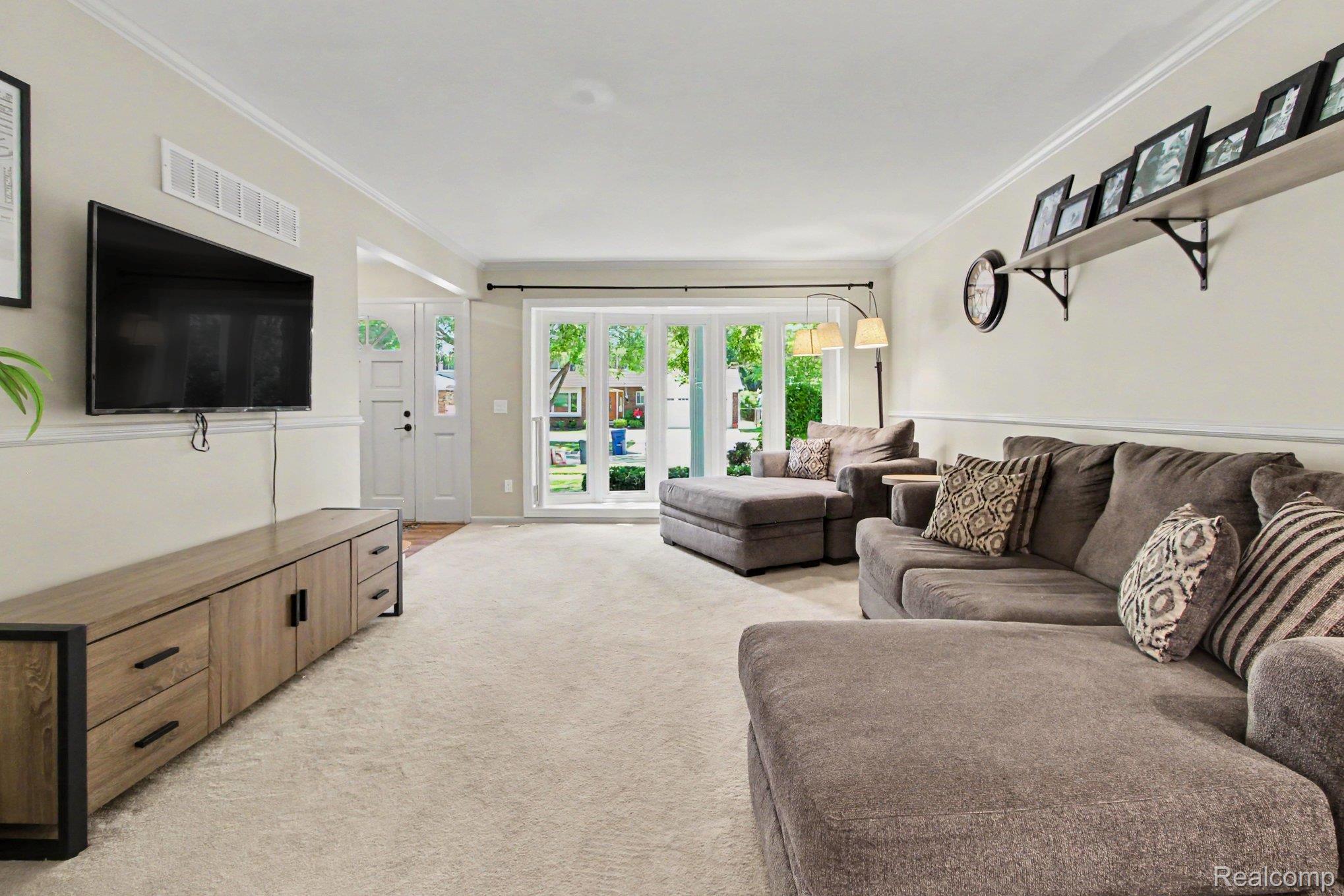 7235 Iron Gate Road Canton, MI 48187 - Photo 11 of 27 Bright living area featuring plush carpeting and a neutral color palette