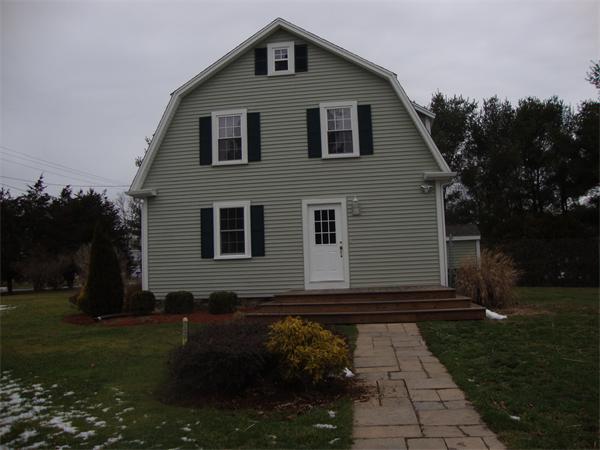 1156 Main Street Acushnet, MA 02743 - Photo 3 of 16 a front view of a house with garden