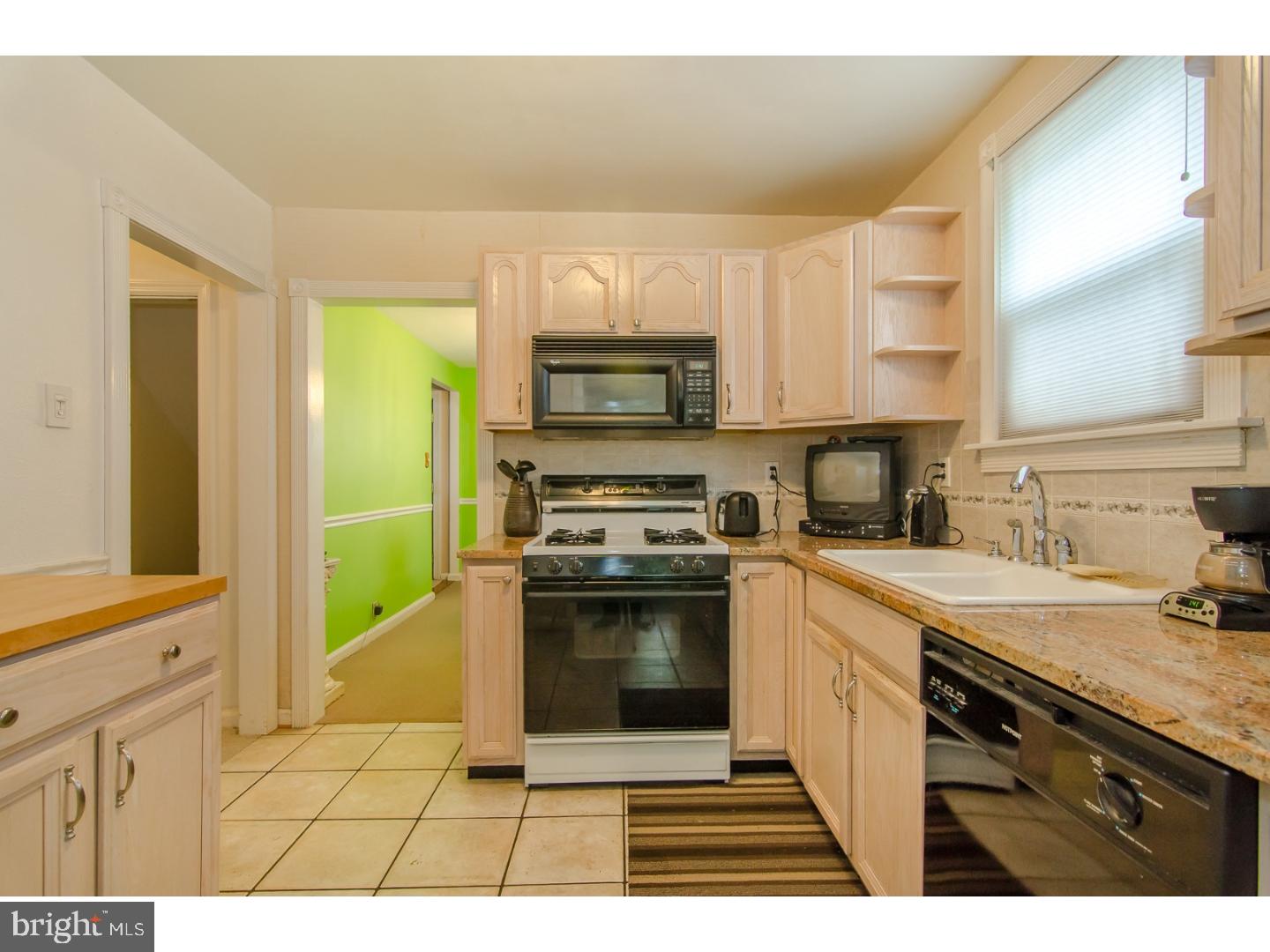 473 Harwicke Road Springfield, PA 19064 - Photo 8 of 25 a kitchen with a sink cabinets stainless steel appliances and a window