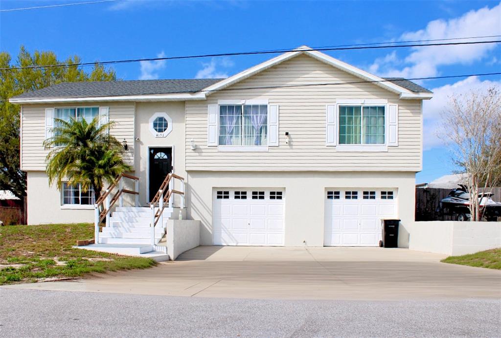 4151 Nelson Road Lake Wales, FL 33898 - Photo 1 of 32 a front view of a house with a yard and garage