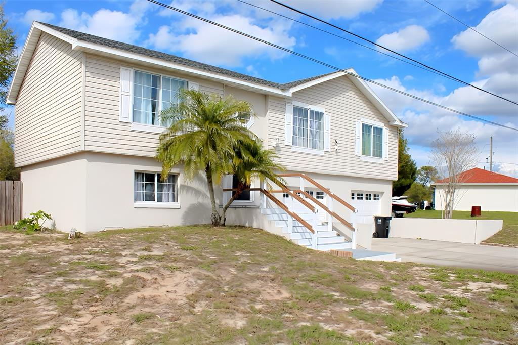 4151 Nelson Road Lake Wales, FL 33898 - Photo 3 of 32 a white house that has a tree in front of it