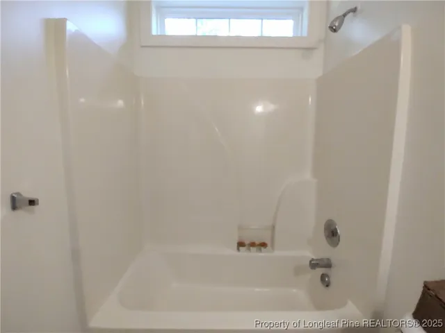 a bathroom with a toilet a sink and wooden floor