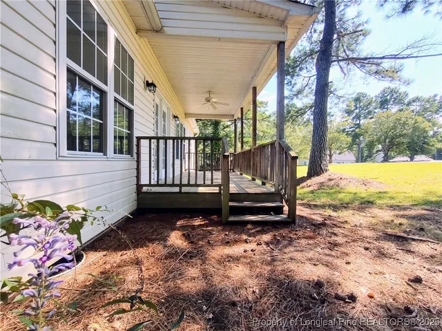a view of a house with backyard and wooden fence