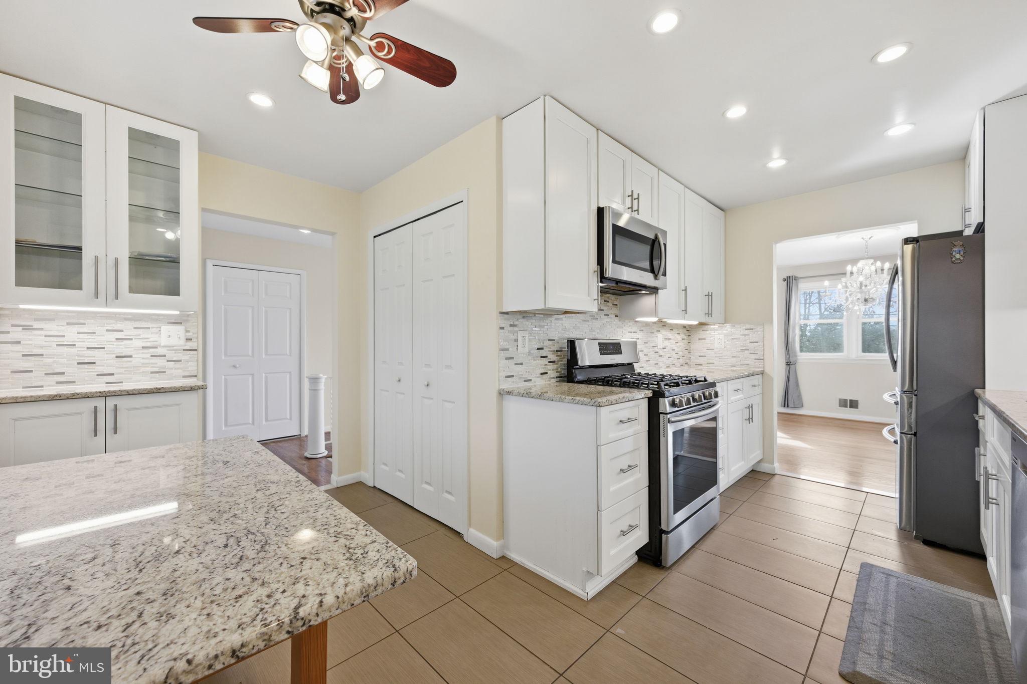 1721 University Boulevard West Silver Spring, MD 20902 - Photo 12 of 38 a kitchen with stainless steel appliances granite countertop a stove refrigerator and microwave