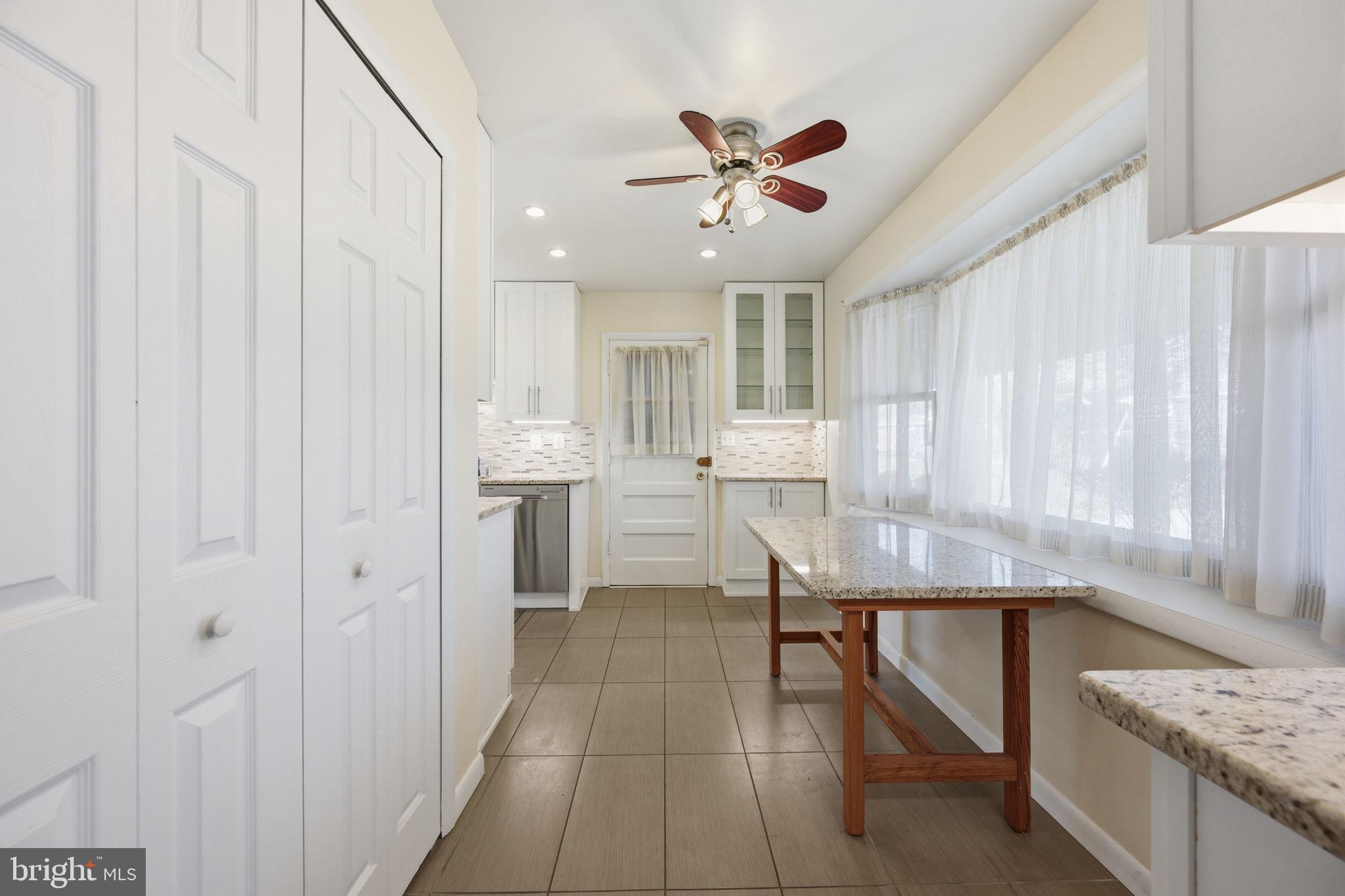 1721 University Boulevard West Silver Spring, MD 20902 - Photo 15 of 38 a room with stainless steel appliances kitchen island granite countertop furniture and a window