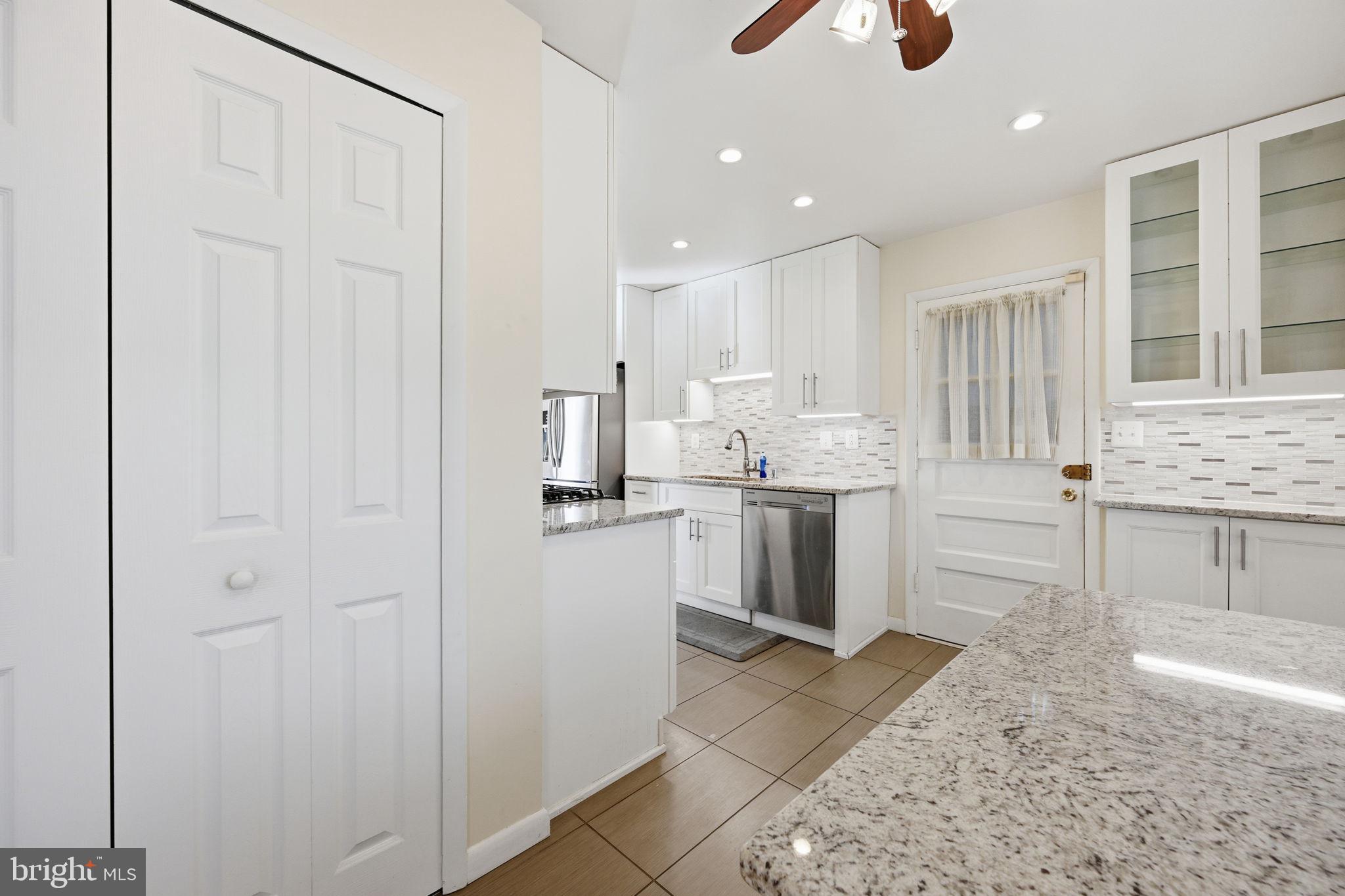 1721 University Boulevard West Silver Spring, MD 20902 - Photo 16 of 38 a kitchen with a sink cabinets and wooden floor