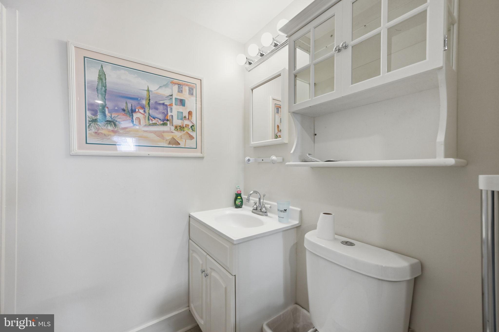 1721 University Boulevard West Silver Spring, MD 20902 - Photo 32 of 38 a bathroom with a sink mirror and toilet