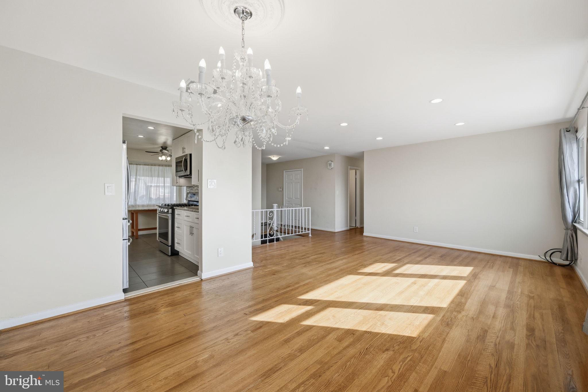 1721 University Boulevard West Silver Spring, MD 20902 - Photo 8 of 38 a view of a room with wooden floor and kitchen