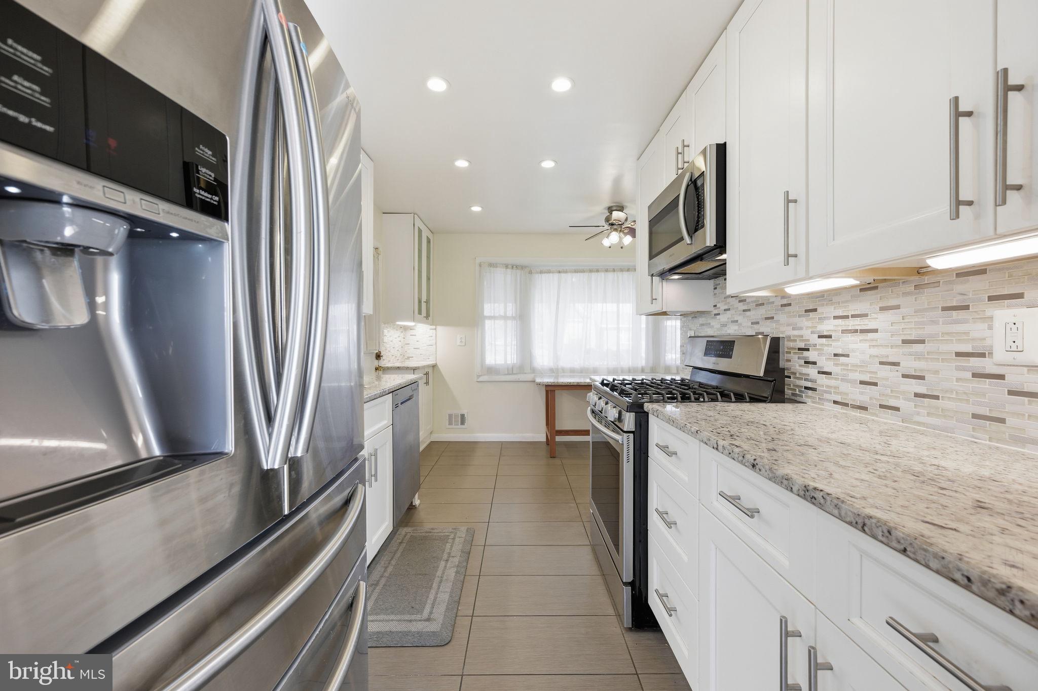 1721 University Boulevard West Silver Spring, MD 20902 - Photo 10 of 38 a kitchen with stainless steel appliances granite countertop a refrigerator a stove and a sink