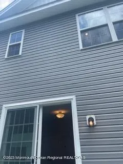 a view of a kitchen with furniture and wooden floor