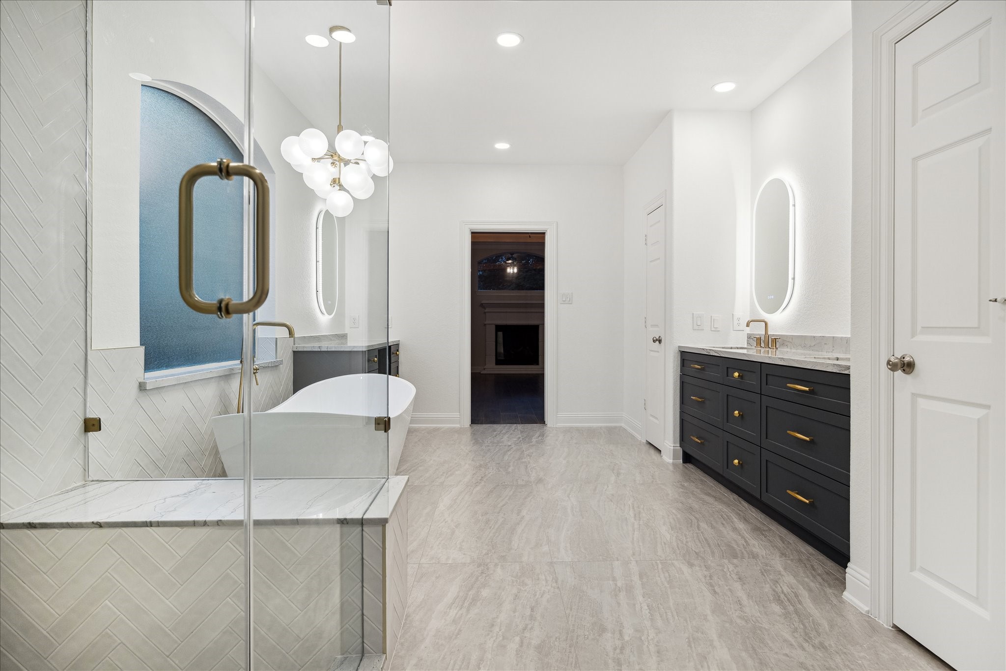 6211 Alameda Point Lane Houston, TX 77041 - Photo 24 of 50 Stunning chandelier, frameless glass walk-in shower, and a dedicated vanity seating area. Every inch of this stunning bathroom was renovated to perfection.