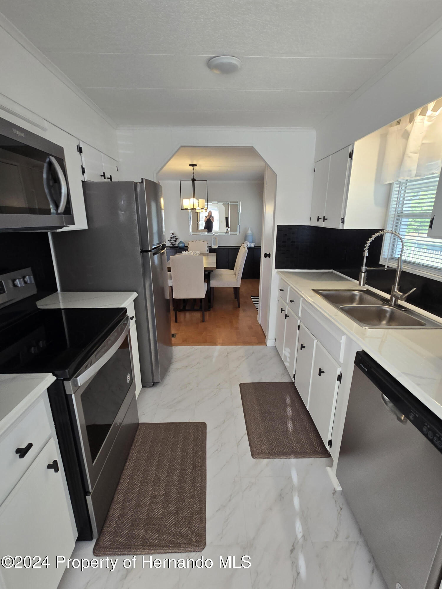 15260 Brookridge Boulevard Brooksville, FL 34613 - Photo 11 of 56 a kitchen with a sink a stove and cabinets