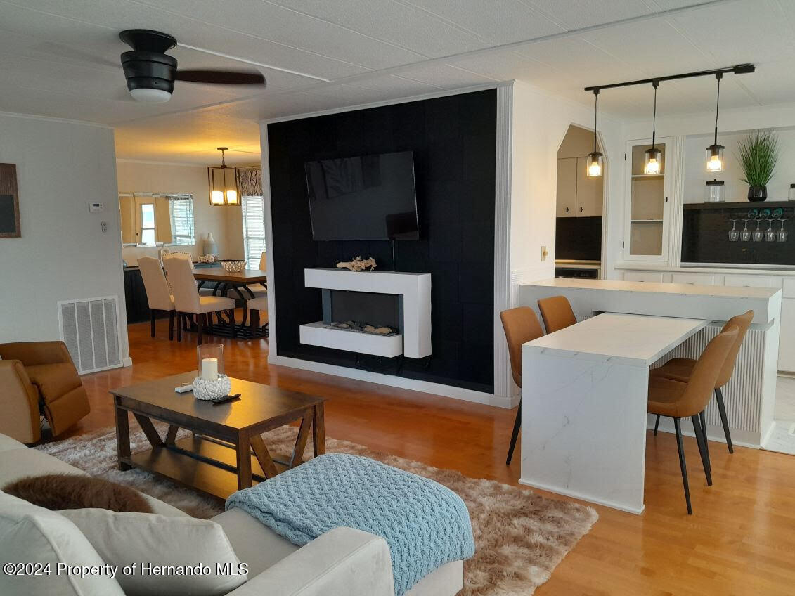 15260 Brookridge Boulevard Brooksville, FL 34613 - Photo 17 of 56 a living room with furniture and a flat screen tv