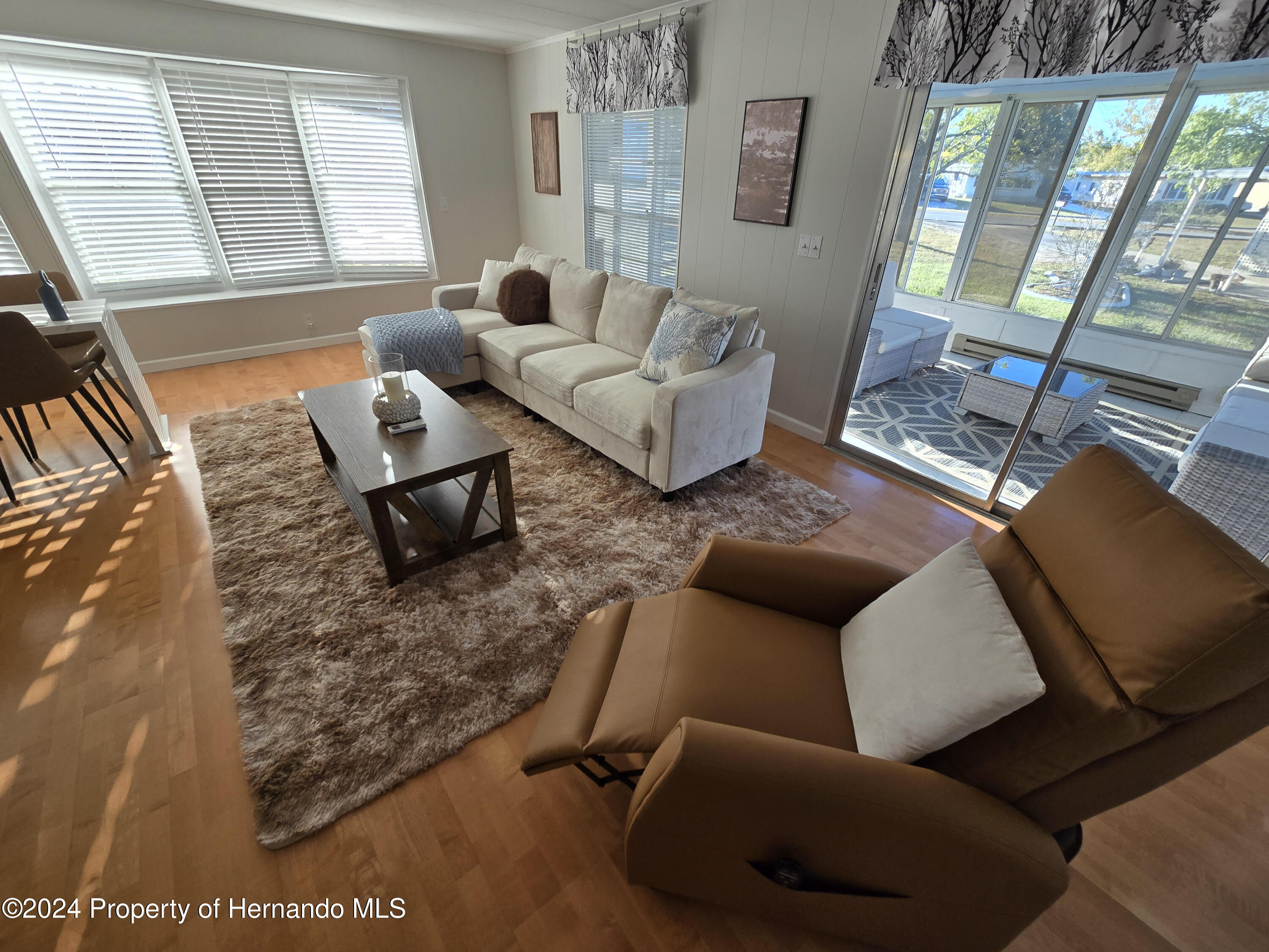 15260 Brookridge Boulevard Brooksville, FL 34613 - Photo 19 of 56 a living room with furniture and a window