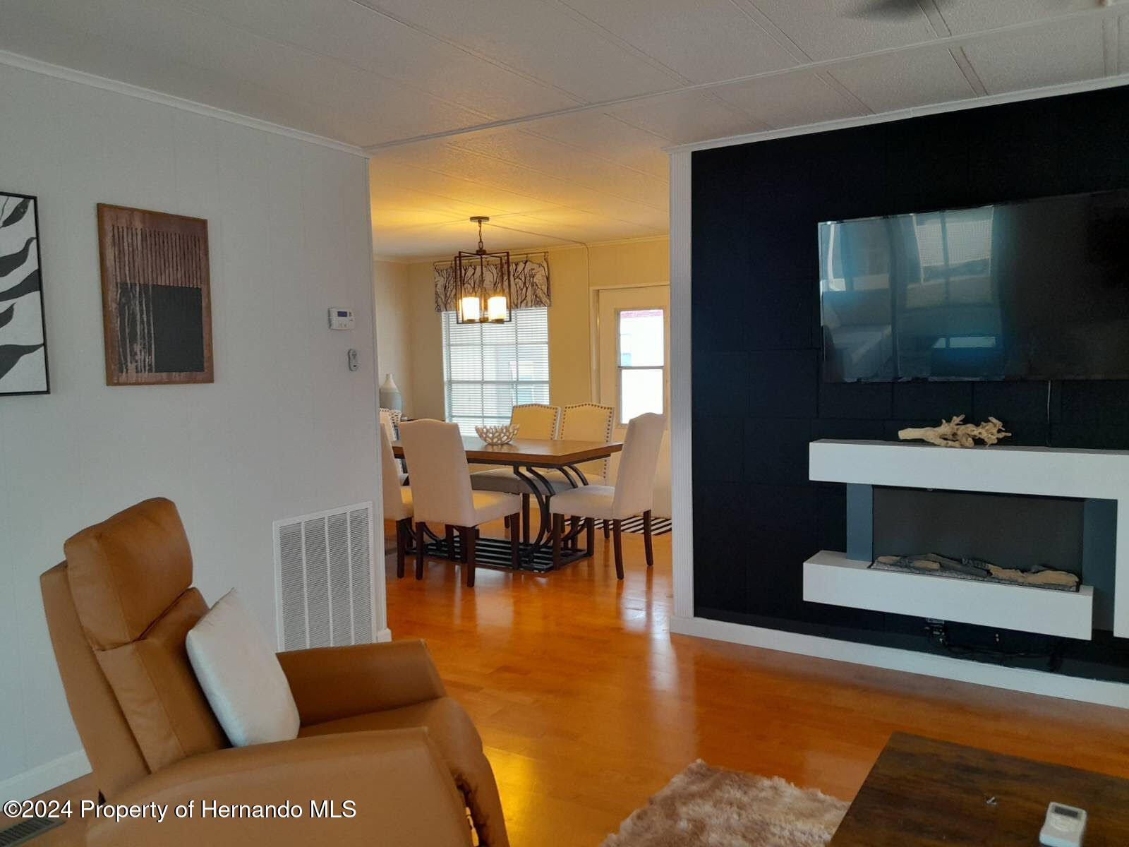 15260 Brookridge Boulevard Brooksville, FL 34613 - Photo 2 of 56 a living room with furniture and a flat screen tv